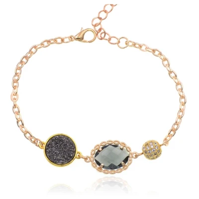 Afbeelding van Goudkleurige verstelbare dames armband met grijs glassteen
