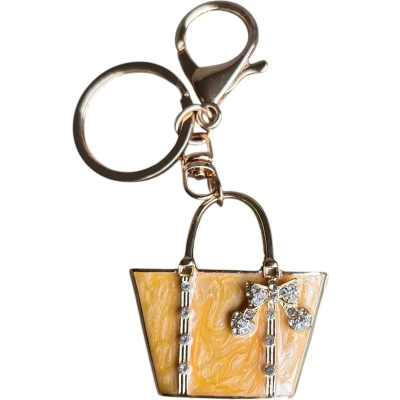 Afbeelding van Sleutelhanger Okergeel Tas met Strass strik ( Goudkleurig ) 4.5 x cm