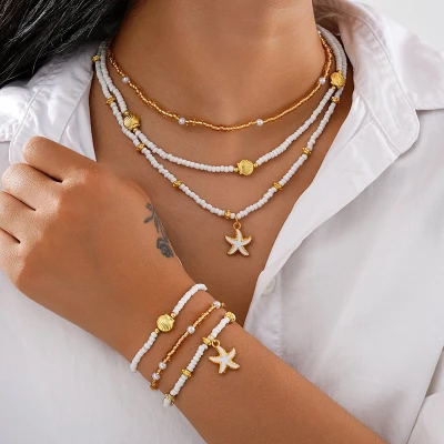 Afbeelding van Jomide Sieradenset Kettingen/Armbandjes Boho Shell Wit/Goudkleurig