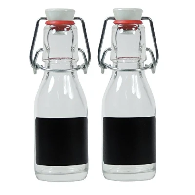 Afbeelding van Viva Haushaltswaren 2 x kleine glazen fles 100 ml leeg met beugelsluiting van porselein om te vullen, gebruiken als transparante sapfles en oliefles (incl. etiketten)